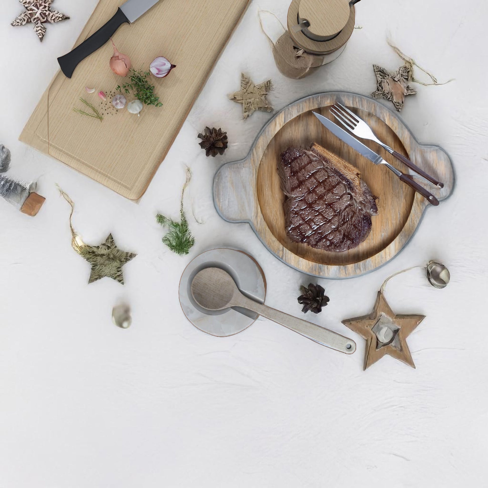 Top-down view of onyx spoon rest and steak plate on a festive table