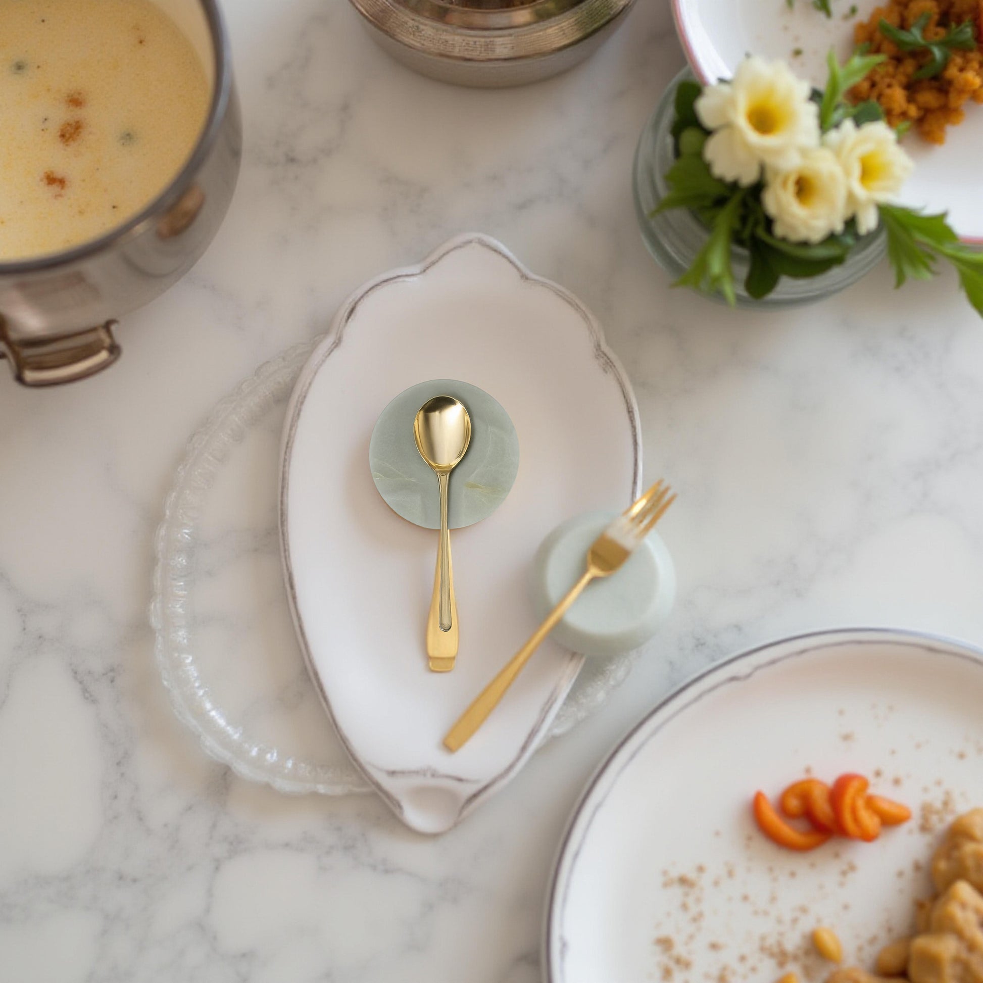 Onyx spoon rest styled with gold spoon and fork on a formal table setting