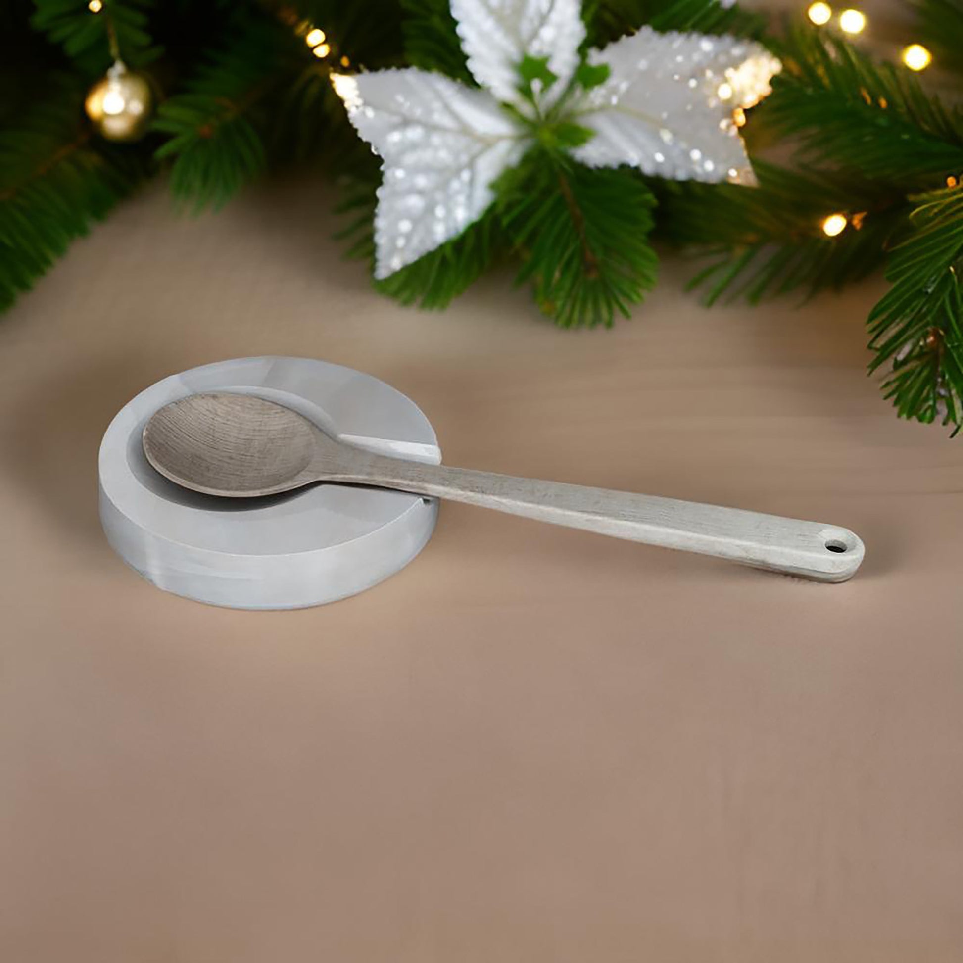 Onyx spoon rest with spoon placed under Christmas decorations